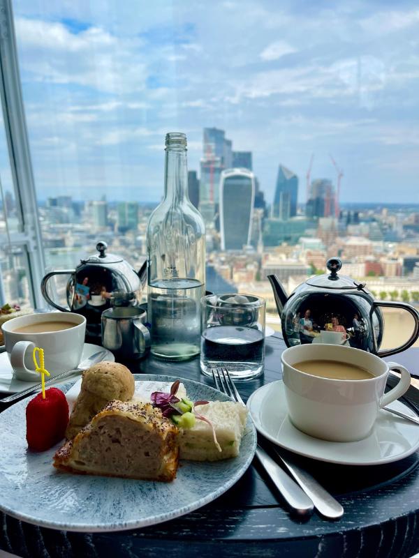Afternoon tea at the Shard with a view of the London skyline beyond.