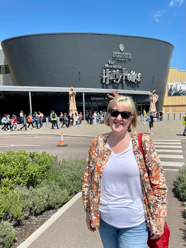 A woman standing outside Harry Potter studios.