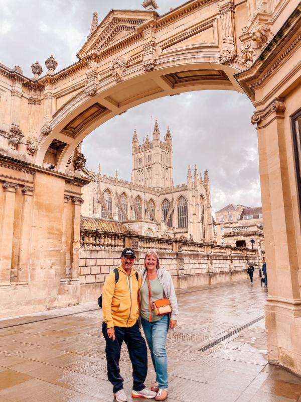 a man and woman in front of a church.