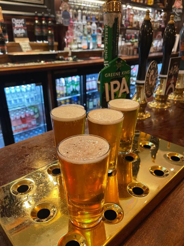 Wash down tasty London foods with some pints of beer in a pub.