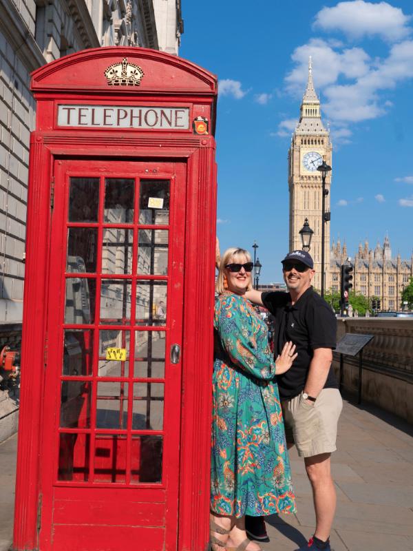 Red phone box, two people and Big Ben.
