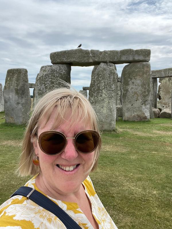 a woman in front of Stonehenge.