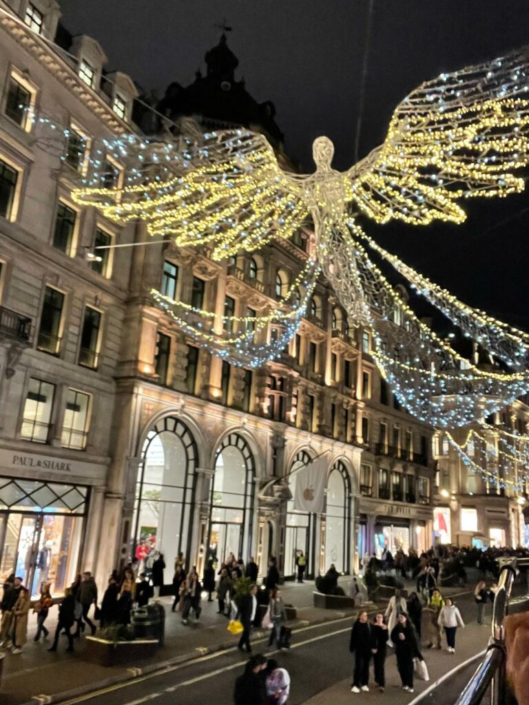 a large angel shaped light decorations over a building
