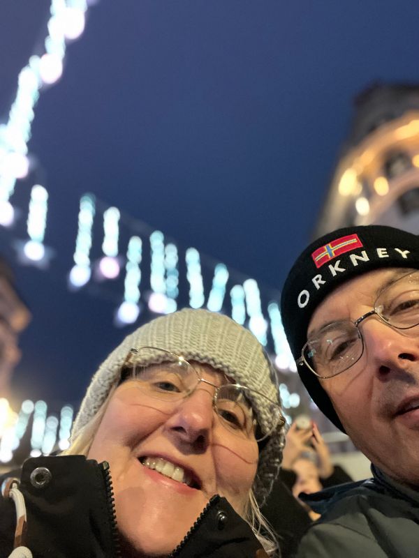 Tracy and Doug on the top deck of a Christmas lights bus tour, passing under the Oxford Street lights.