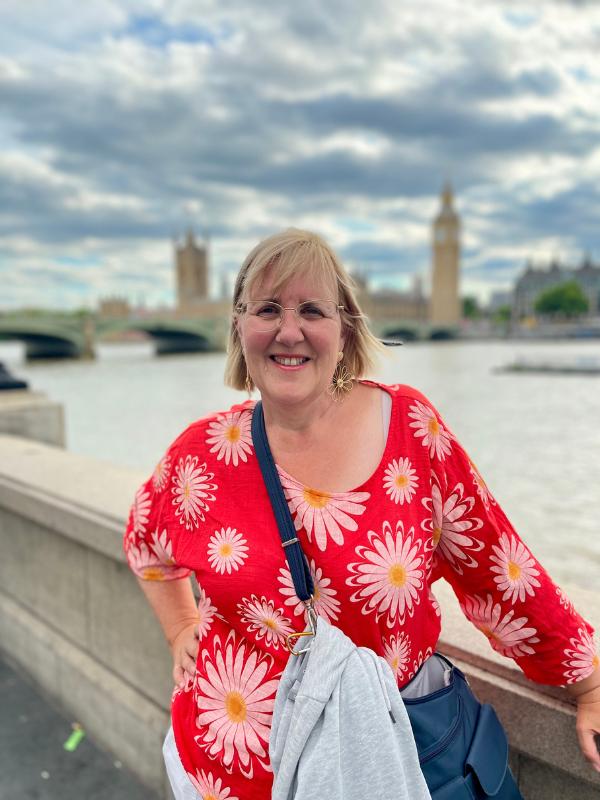 A woman with the Houses of Parliament behind her.