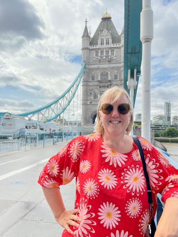 A woman standing on Tower Bridge.