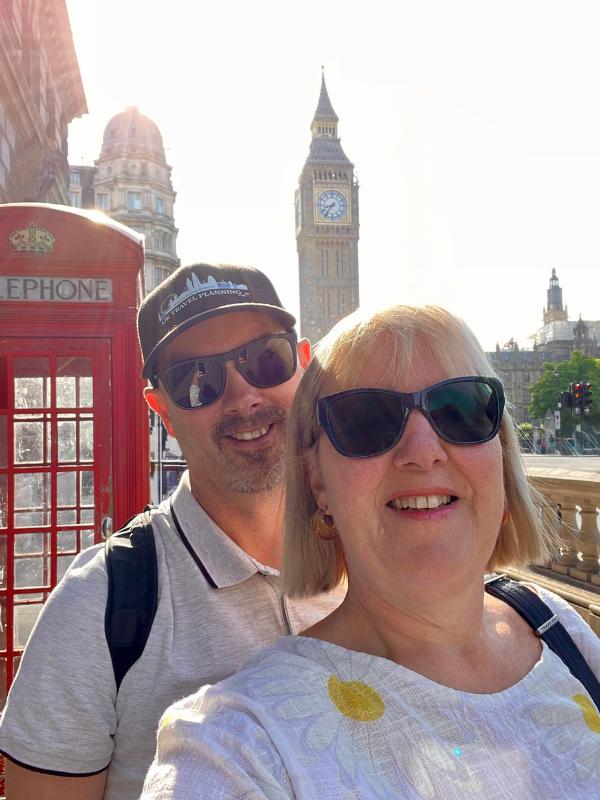 Man and woman with Big Ben and a red London phone booth.