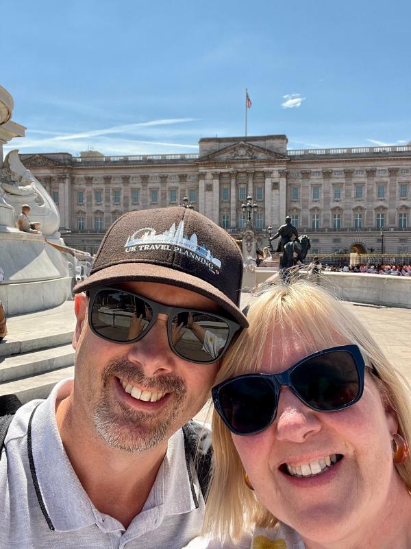 Man and woman outside Buckingham Palace.