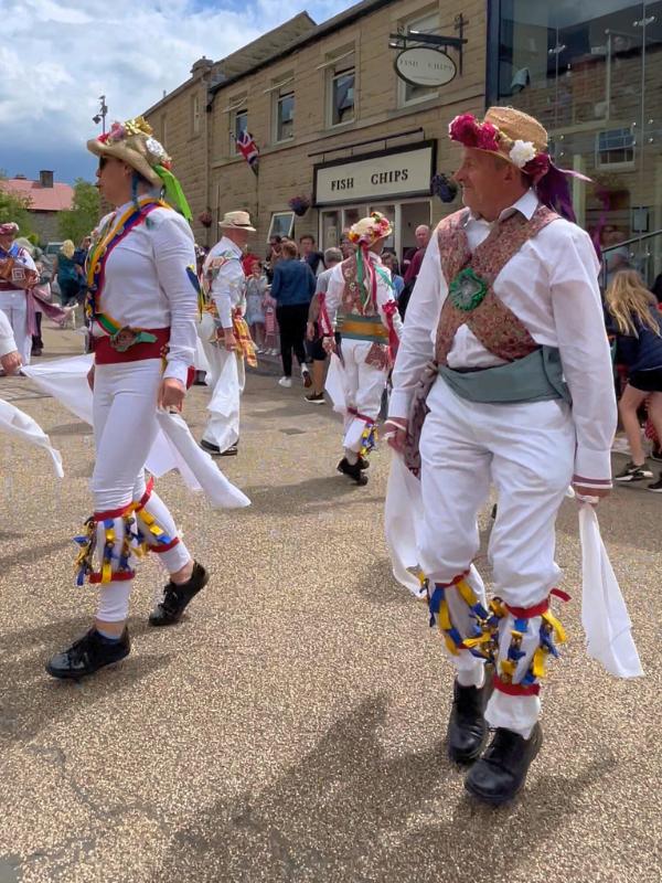 Morris dancers in traditional costume — an example of the folk dancing you can see at events across England in May