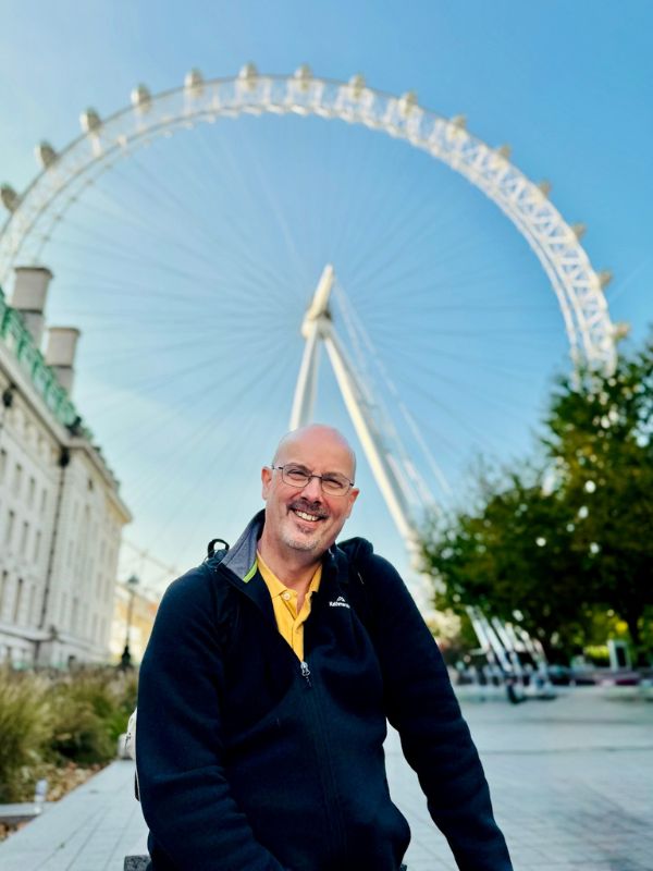 Doug from London Travel Planning outside the London Eye on a clear October morning