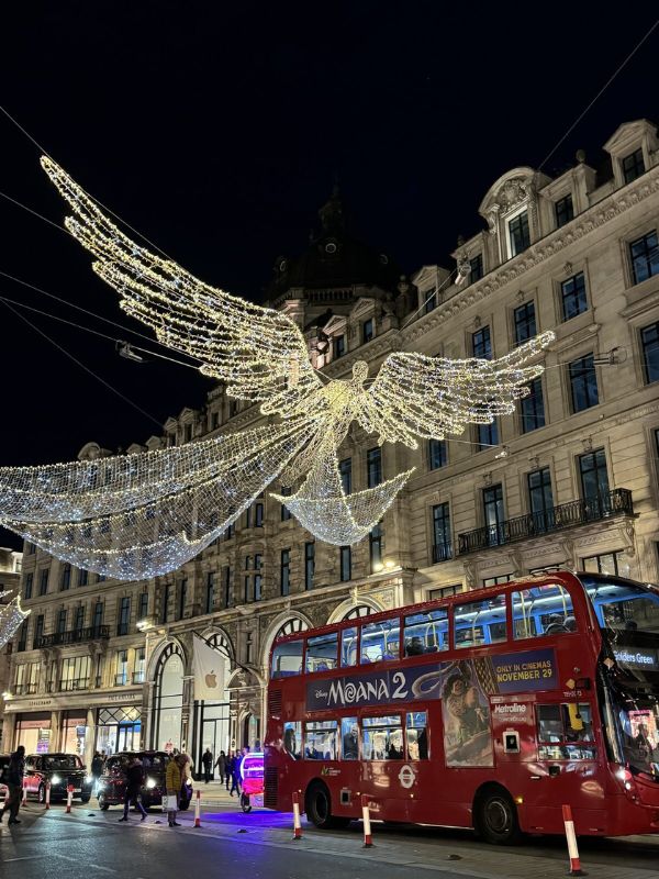 Regents street angel and a red london bus 