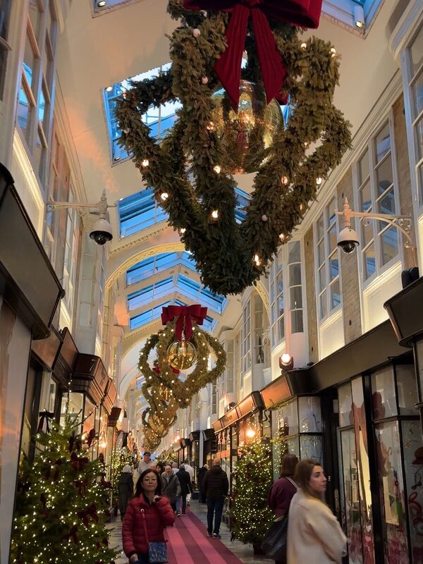 Christmas wreaths and decorated trees inside Burlington Arcade in London in November