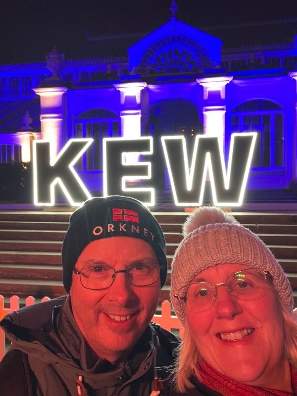 Tracy and Doug Collins at the lit Kew sign on the Christmas at Kew trail