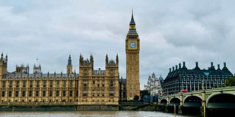 he Houses of Parliament and Big Ben across the Thames from Westminster Bridge on an overcast October day in London