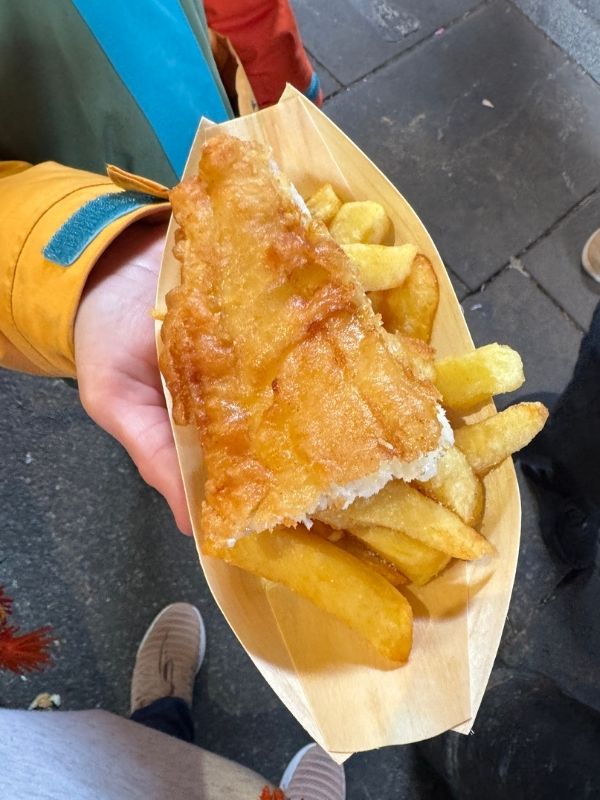 Battered fish and thick-cut chips in a wooden tray at Borough Market