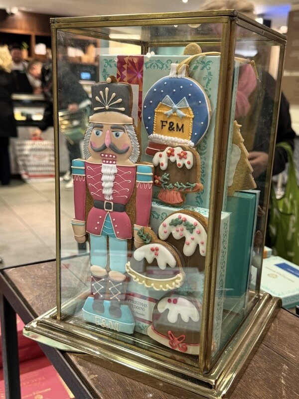 Fortnum and Mason iced gingerbread nutcracker and Christmas biscuits in a glass display case