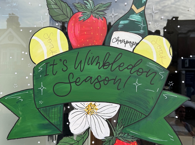 Events in London in July: an "It's Wimbledon season" sign with strawberries and tennis balls