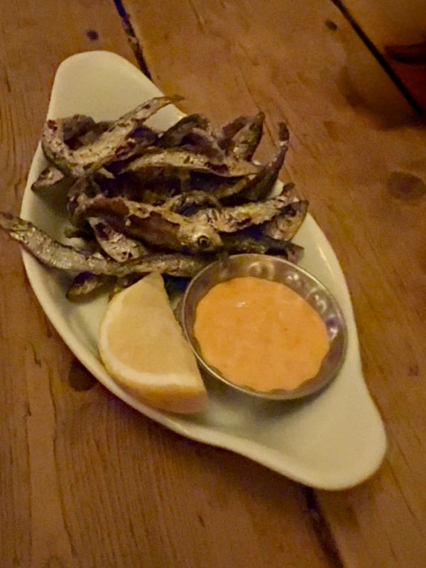 A plate of devilled whitebait served whole with lemon and spiced mayonnaise