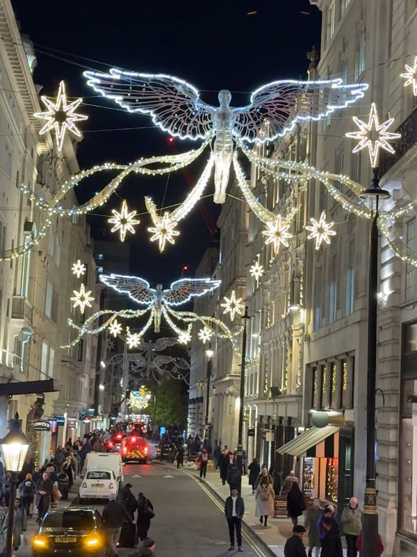 The angel Christmas lights above London streets at night