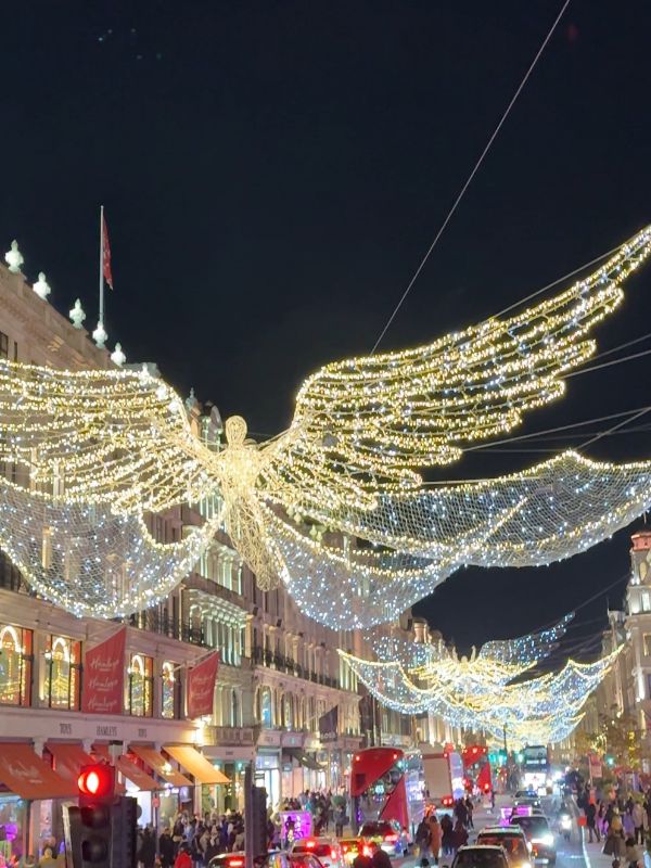 The Regent Street Christmas angels lit up above Hamleys and the red buses below.