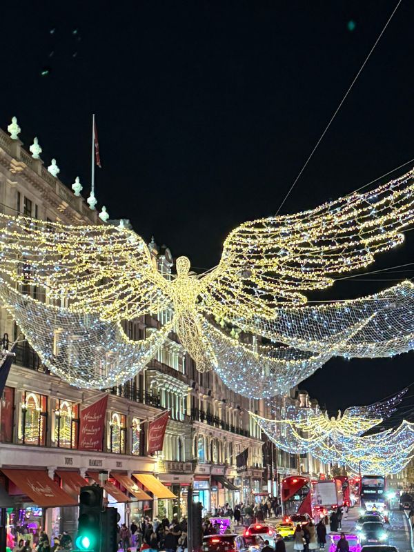 A Spirit of Christmas angel light spread across Regent Street at night.