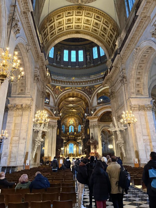 Congregation seated in the nave of St Paul's Cathedral looking towards the dome.