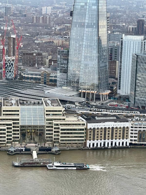 The Shard and London Bridge City Pier from a boat on the Thames in winter