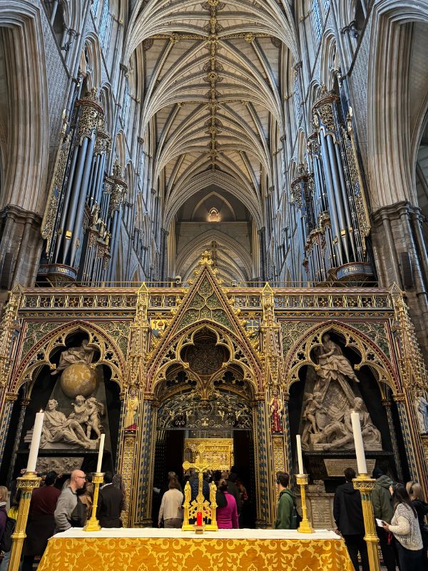 The gilded quire screen and organ pipes beneath the vaulted ceiling of Westminster Abbey
