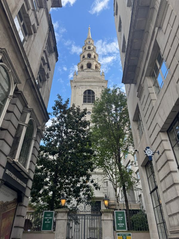 The tiered white spire of a Wren church rising between buildings off Fleet Street