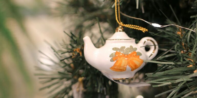 Teapot ornament hanging on a Christmas tree, for a guide to Christmas afternoon tea in London