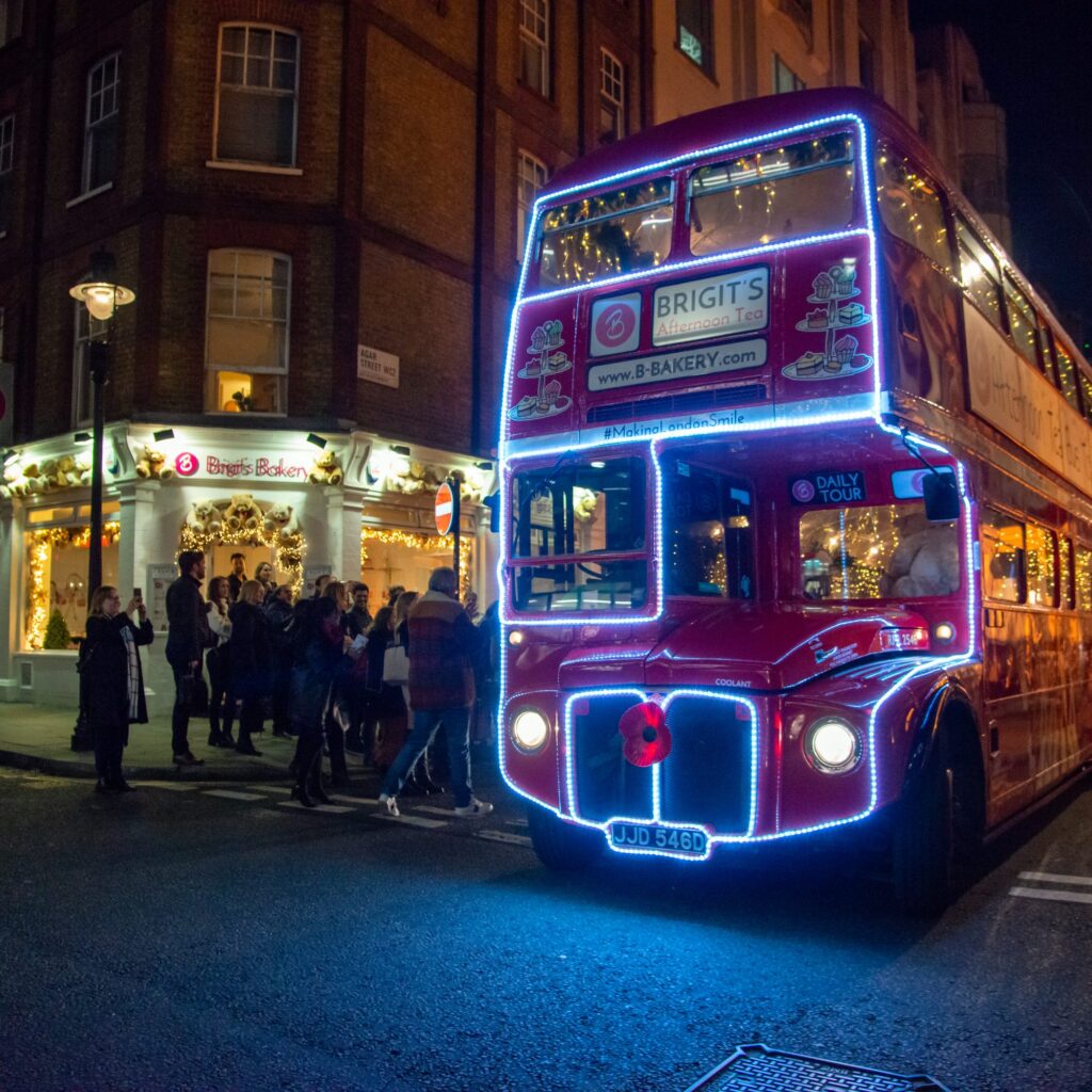 Brigit’s Bakery Christmas lights afternoon tea bus, a lit-up red Routemaster outside the bakery in Covent Garden.