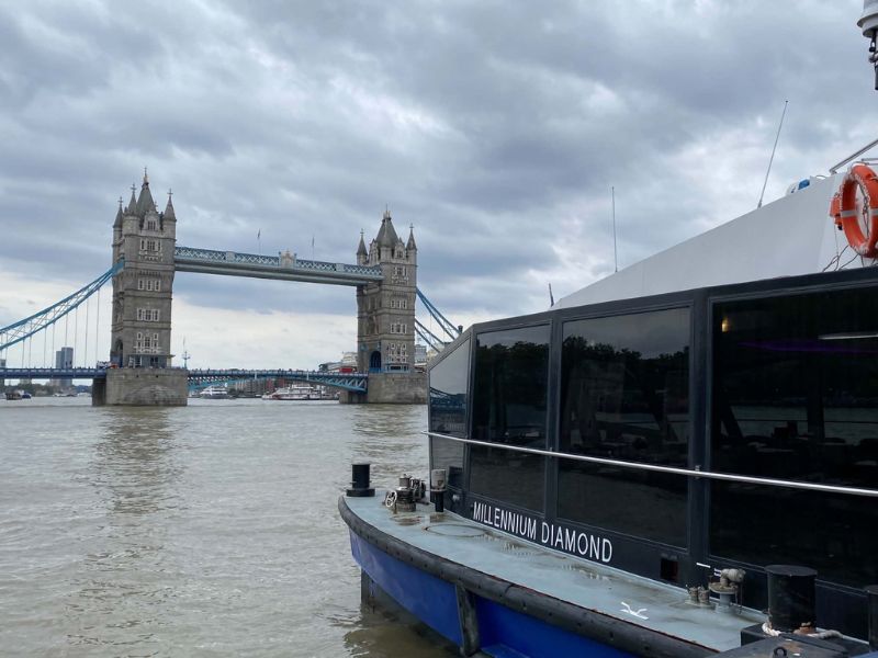 City Cruises boat Millennium Diamond at Tower Millennium Pier, a departure point for dinner cruises in London, with Tower Bridge behind