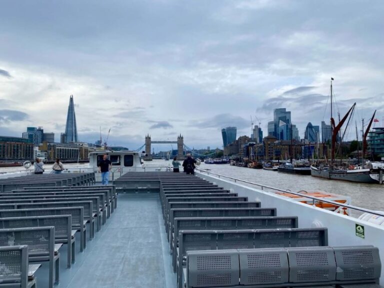 Open-top deck seating on a City Cruises boat with Tower Bridge and the Shard in the distance