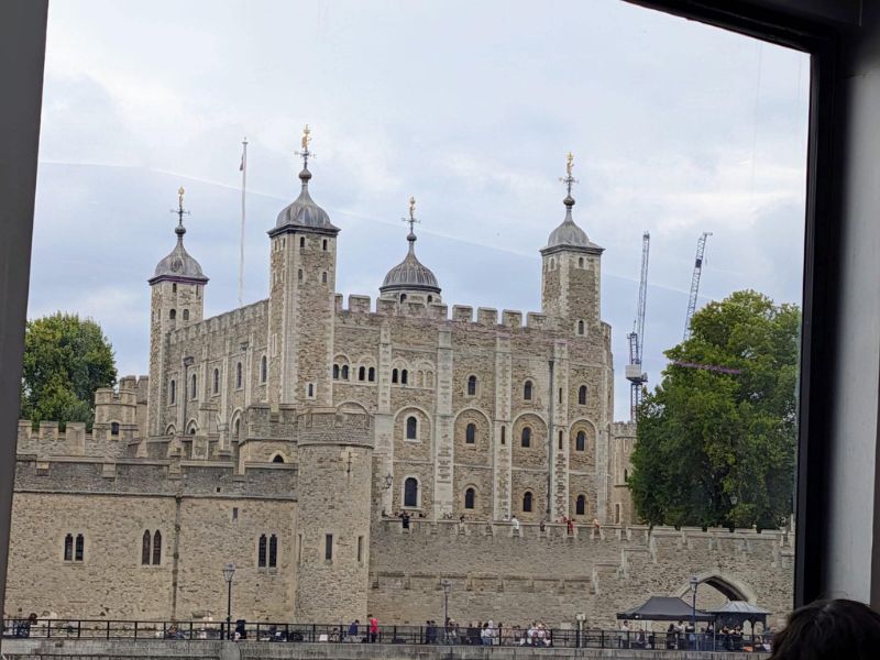 Tower of London seen through the window of a City Cruises boat